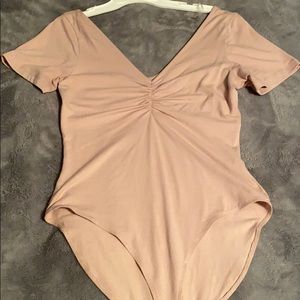 peach v neck body suit. never worn.